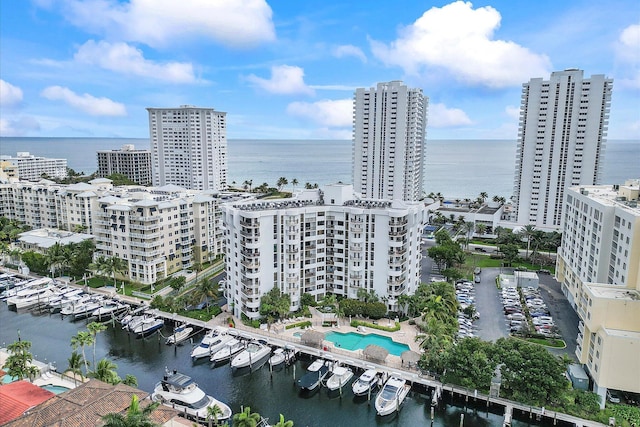 bird's eye view of a large body of water, a pool area, and a marina