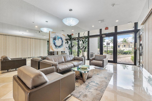 building lobby with a textured ceiling, recessed lighting, and floor to ceiling windows