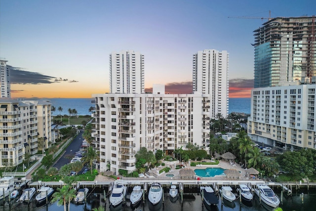 view of building exterior with a water view and a city view