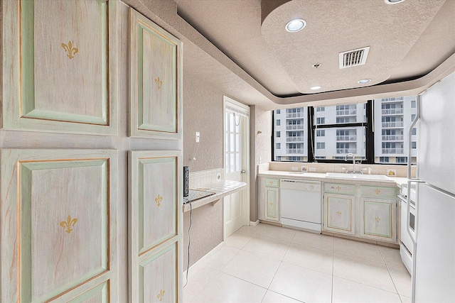 kitchen with white dishwasher, a sink, a textured ceiling, light tile patterned flooring, and light countertops