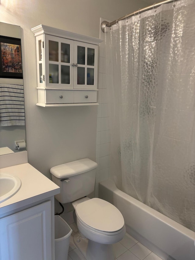 full bath featuring tile patterned flooring, shower / tub combo with curtain, toilet, and vanity