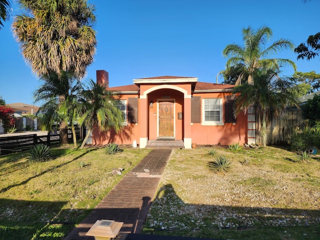 832 N D St, Lake Worth Beach, FL 33460 - view of front of property with stucco siding and a chimney