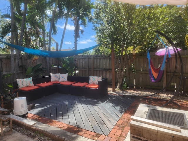 832 N D St, Lake Worth Beach, FL 33460 - wooden terrace featuring a fenced backyard and an outdoor living space