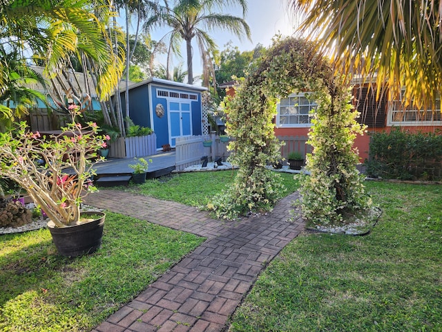 832 N D St, Lake Worth Beach, FL 33460 - view of yard featuring a wooden deck, an outbuilding, and a storage unit