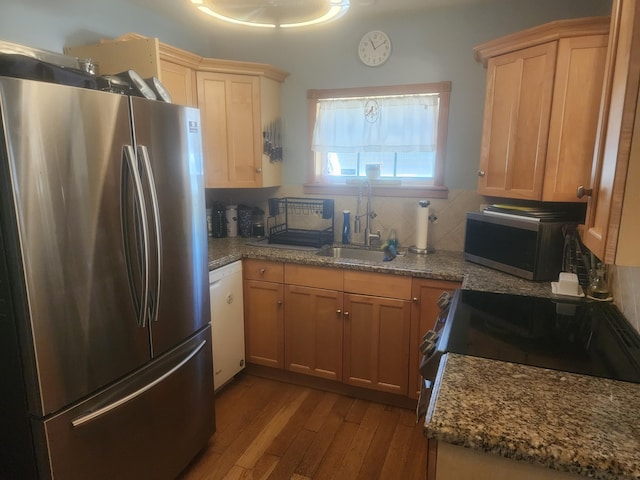 832 N D St, Lake Worth Beach, FL 33460 - kitchen featuring stainless steel appliances, a sink, dark wood-style floors, decorative backsplash, and dark stone countertops