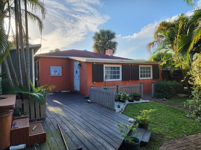 832 N D St, Lake Worth Beach, FL 33460 - rear view of property with a wooden deck and stucco siding