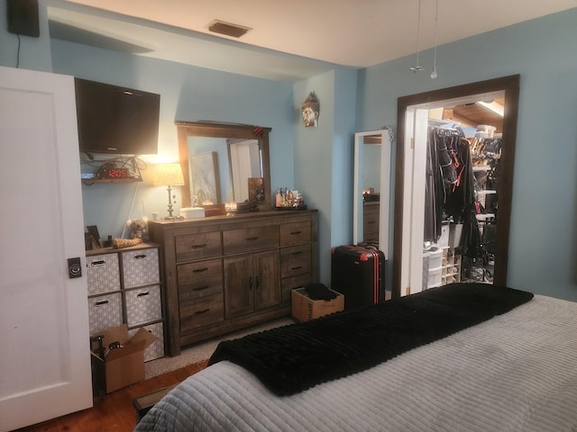 832 N D St, Lake Worth Beach, FL 33460 - bedroom featuring wood finished floors and a walk in closet