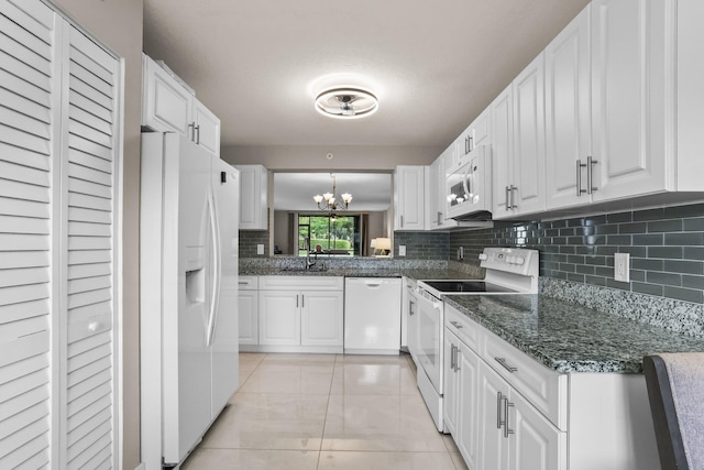 15365 Lakes Of Delray Blvd Unit 106, Delray Beach, FL 33484 - kitchen with white appliances, a chandelier, backsplash, white cabinetry, and a sink