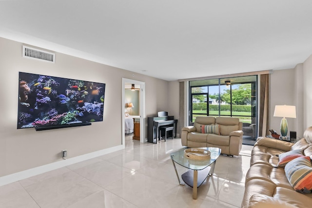 15365 Lakes Of Delray Blvd Unit 106, Delray Beach, FL 33484 - living area featuring baseboards, a wall of windows, and light tile patterned floors