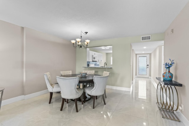 15365 Lakes Of Delray Blvd Unit 106, Delray Beach, FL 33484 - dining space with baseboards, a chandelier, and light tile patterned floors