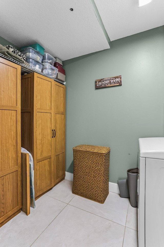 15365 Lakes Of Delray Blvd Unit 106, Delray Beach, FL 33484 - washroom with cabinet space, light tile patterned floors, and washer / dryer