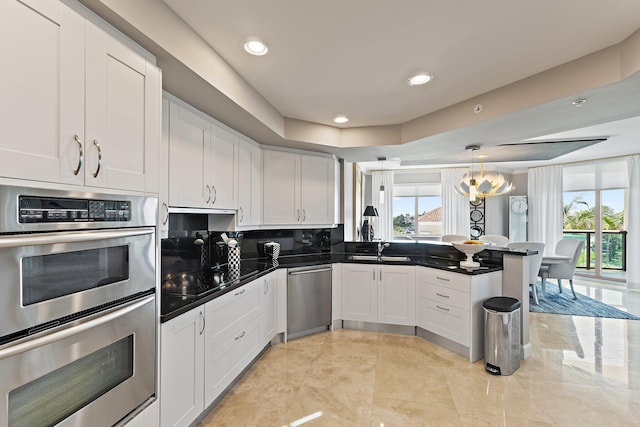 3610 Gardens Pkwy Unit 403A, Palm Beach Gardens, FL 33410 - kitchen with appliances with stainless steel finishes, a sink, a peninsula, dark countertops, and recessed lighting