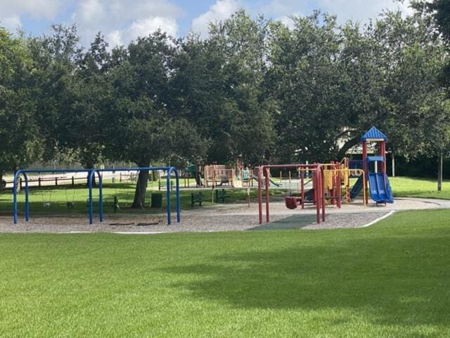 community jungle gym featuring a lawn