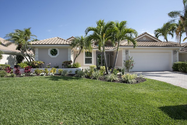 3333 Southern Cay Dr, Jupiter, FL 33477 - mediterranean / spanish house with stucco siding, an attached garage, a tile roof, driveway, and a front yard