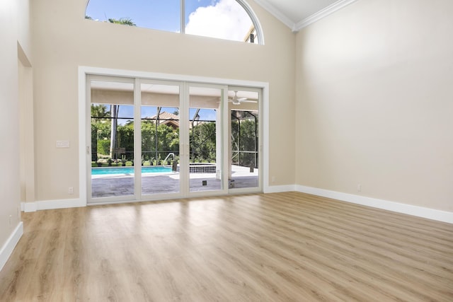 3333 Southern Cay Dr, Jupiter, FL 33477 - empty room with ornamental molding, plenty of natural light, wood finished floors, baseboards, and a towering ceiling