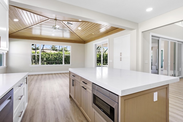 3333 Southern Cay Dr, Jupiter, FL 33477 - kitchen with wooden ceiling, appliances with stainless steel finishes, light countertops, light wood-style floors, and a center island