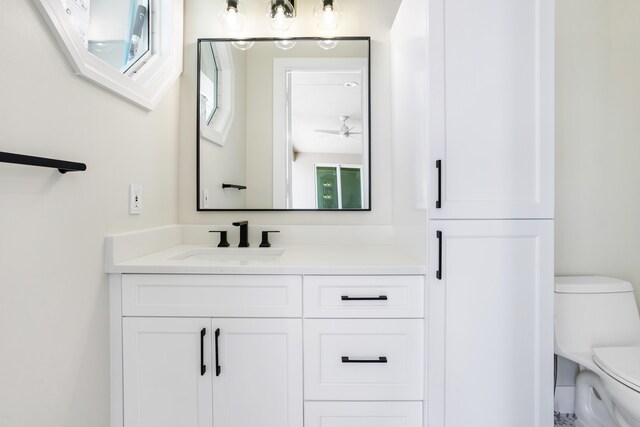 3333 Southern Cay Dr, Jupiter, FL 33477 - bathroom featuring toilet, vanity, and ceiling fan