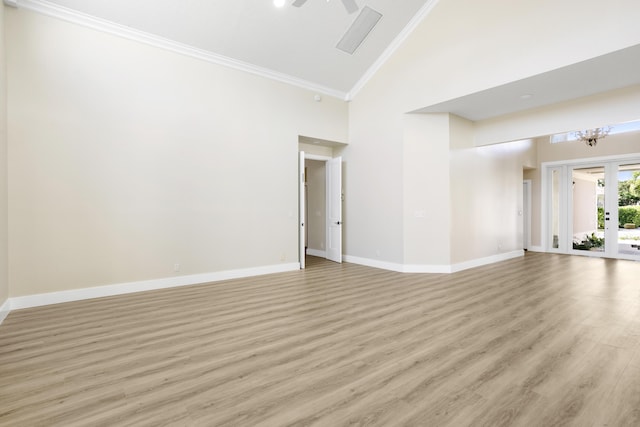 3333 Southern Cay Dr, Jupiter, FL 33477 - spare room with high vaulted ceiling, ornamental molding, light wood finished floors, baseboards, and a chandelier