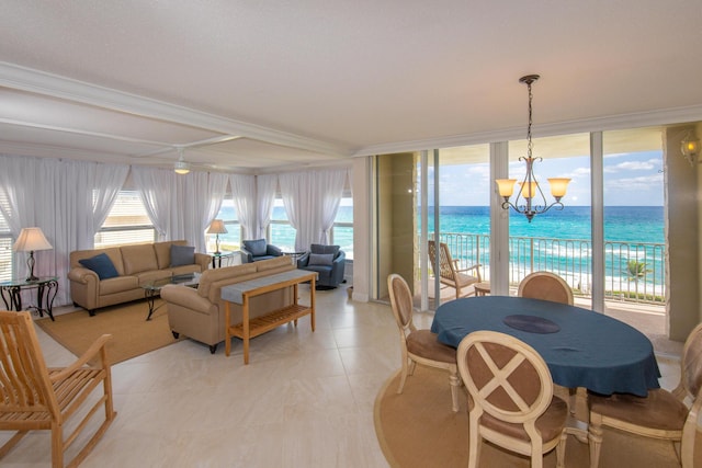 3230 S Ocean Blvd Unit D511, Palm Beach, FL 33480 - living area featuring a chandelier, a water view, crown molding, and light tile patterned flooring