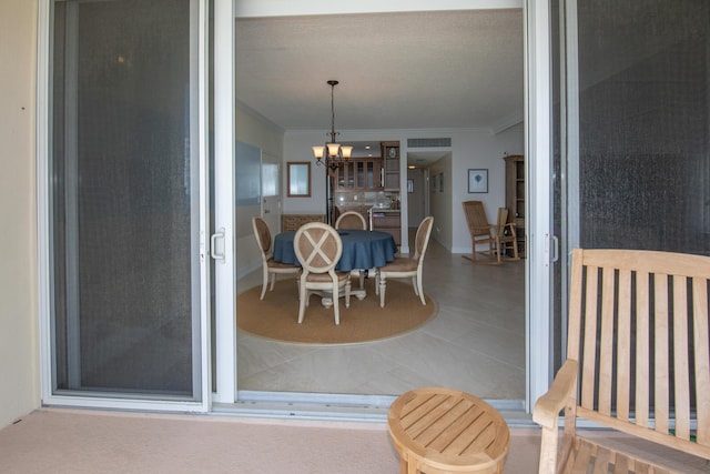 3230 S Ocean Blvd Unit D511, Palm Beach, FL 33480 - dining room featuring crown molding and a chandelier