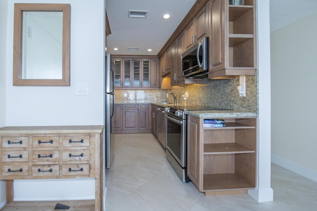 3230 S Ocean Blvd Unit D511, Palm Beach, FL 33480 - kitchen featuring stainless steel appliances, open shelves, light stone counters, tasteful backsplash, and a sink