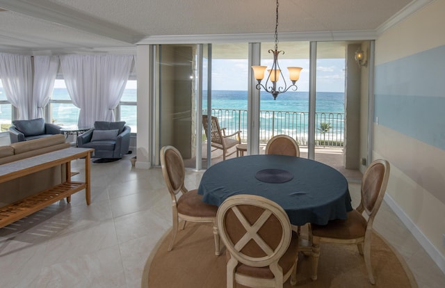 3230 S Ocean Blvd Unit D511, Palm Beach, FL 33480 - dining space with a chandelier, crown molding, expansive windows, healthy amount of natural light, and a water view