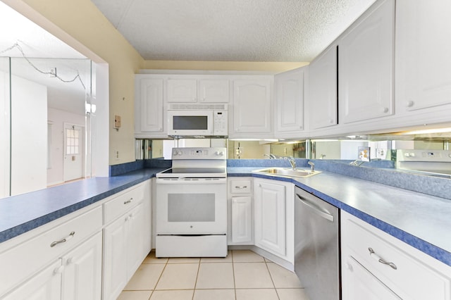 302 Knotty Pine Cir Unit D-1, Greenacres, FL 33463 - kitchen featuring white appliances, a sink, white cabinets, light tile patterned floors, and dark countertops