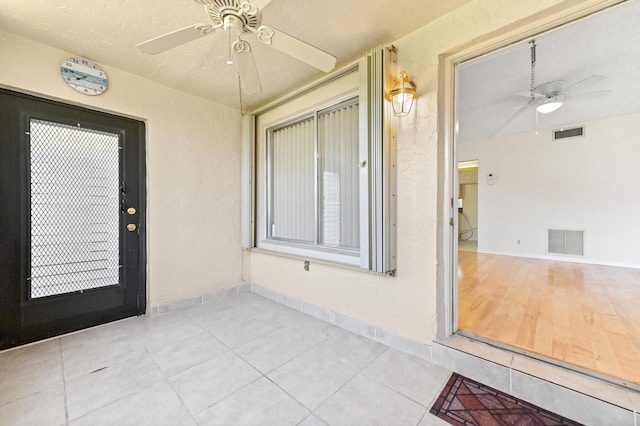 302 Knotty Pine Cir Unit D-1, Greenacres, FL 33463 - view of exterior entry featuring ceiling fan, a patio area, and stucco siding