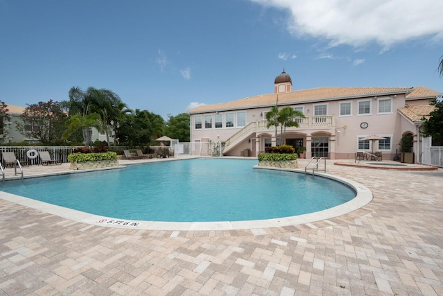 166 SW Peacock Blvd Unit 34-205, Port Saint Lucie, FL 34986 - community pool featuring fence, a patio, and stairway