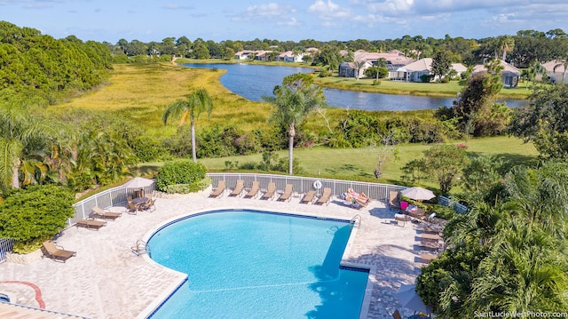 166 SW Peacock Blvd Unit 34-205, Port Saint Lucie, FL 34986 - community pool with fence, a water view, a patio, and view of scattered trees