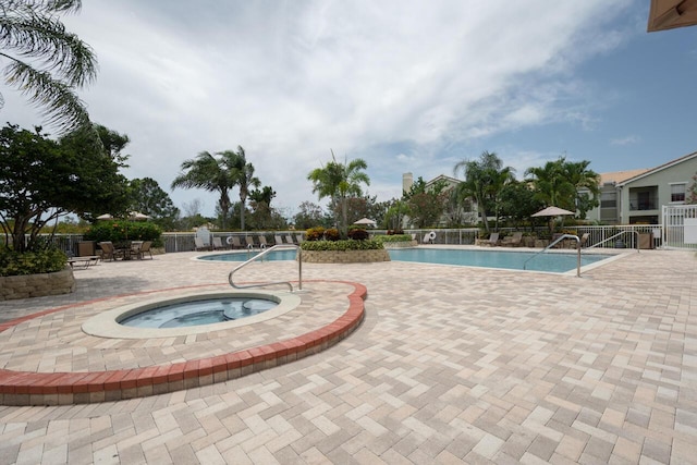 166 SW Peacock Blvd Unit 34-205, Port Saint Lucie, FL 34986 - community pool featuring a community hot tub, fence, and a patio