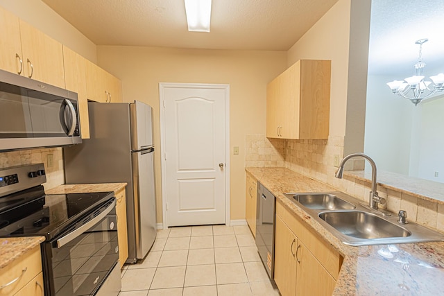 166 SW Peacock Blvd Unit 34-205, Port Saint Lucie, FL 34986 - kitchen with appliances with stainless steel finishes, light brown cabinetry, and a sink