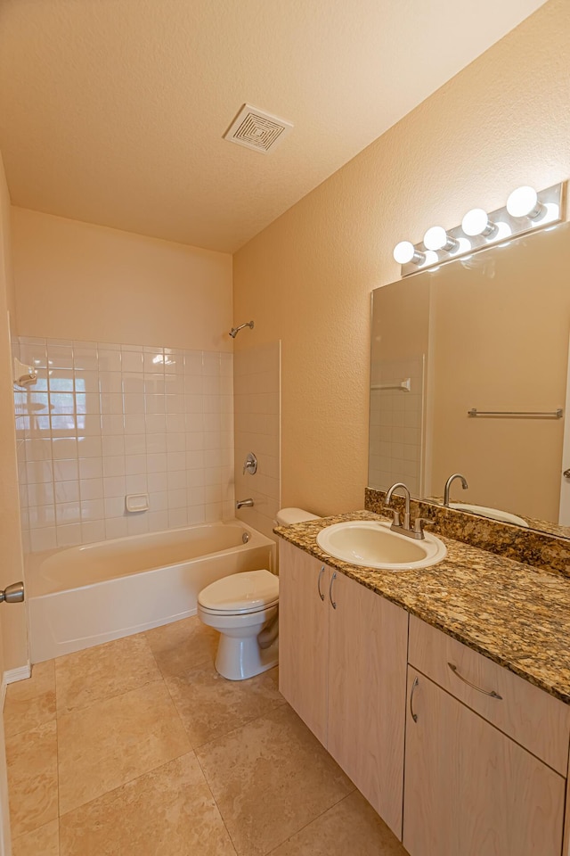 166 SW Peacock Blvd Unit 34-205, Port Saint Lucie, FL 34986 - full bathroom with a textured wall, shower / bathtub combination, toilet, vanity, and tile patterned flooring