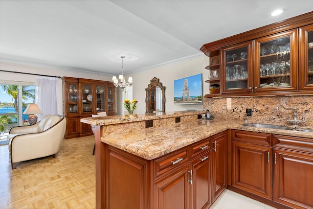 250 Bradley Pl Unit 408, Palm Beach, FL 33480 - kitchen featuring a sink, light stone counters, a peninsula, a chandelier, and tasteful backsplash