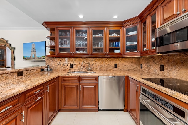 250 Bradley Pl Unit 408, Palm Beach, FL 33480 - kitchen featuring appliances with stainless steel finishes, a sink, light stone counters, light tile patterned floors, and crown molding
