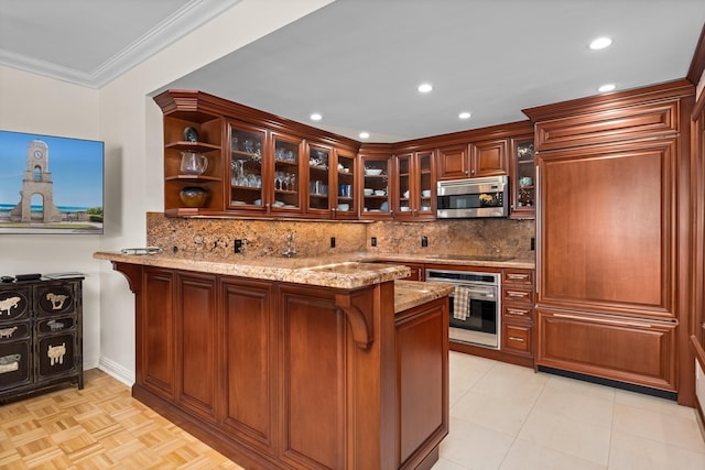 250 Bradley Pl Unit 408, Palm Beach, FL 33480 - kitchen with appliances with stainless steel finishes, a peninsula, light stone counters, glass insert cabinets, and decorative backsplash