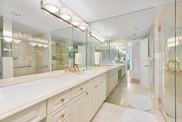 250 Bradley Pl Unit 408, Palm Beach, FL 33480 - bathroom featuring tile patterned flooring, double vanity, and a shower stall