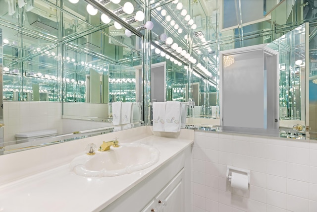 250 Bradley Pl Unit 408, Palm Beach, FL 33480 - bathroom with vanity, toilet, and tile walls