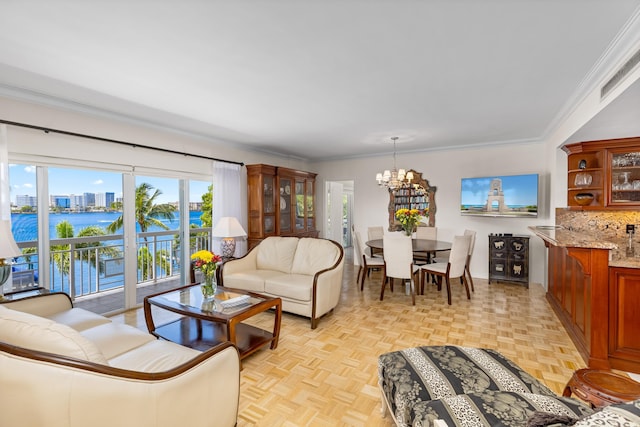 250 Bradley Pl Unit 408, Palm Beach, FL 33480 - living area featuring a chandelier, a water view, and ornamental molding