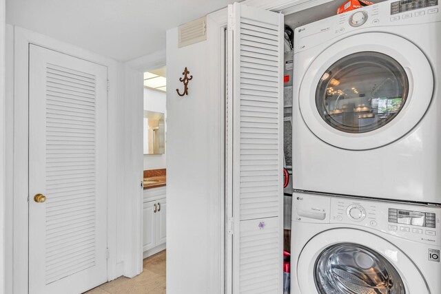 711 NE Harbour Ter Unit 4120, Boca Raton, FL 33431 - washroom with stacked washing machine and dryer
