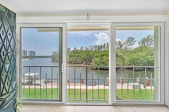 711 NE Harbour Ter Unit 4120, Boca Raton, FL 33431 - doorway to outside featuring a water view and tile patterned flooring