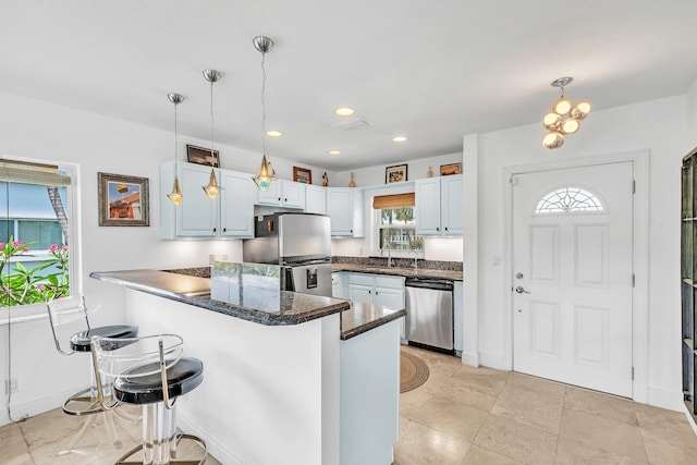 711 NE Harbour Ter Unit 4120, Boca Raton, FL 33431 - kitchen featuring appliances with stainless steel finishes, a peninsula, decorative light fixtures, a breakfast bar area, and recessed lighting