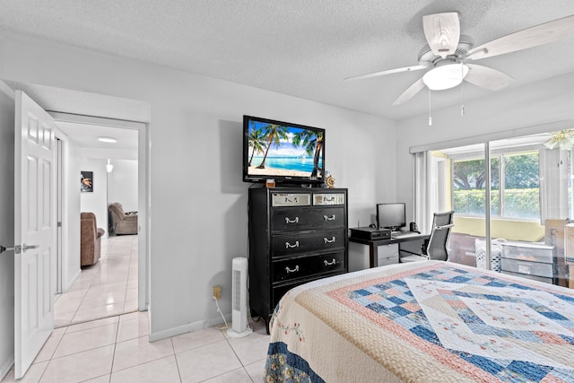 2538 Boundbrook Dr S Unit 140, West Palm Beach, FL 33406 - bedroom featuring light tile patterned floors, baseboards, an office area, a textured ceiling, and ceiling fan