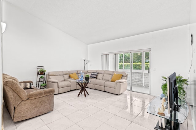 2538 Boundbrook Dr S Unit 140, West Palm Beach, FL 33406 - living area featuring lofted ceiling, light tile patterned flooring, and a textured ceiling
