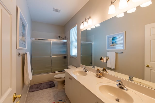 7897 Monarch Ct, Delray Beach, FL 33446 - full bath featuring tile patterned flooring, toilet, bath / shower combo with glass door, and double vanity