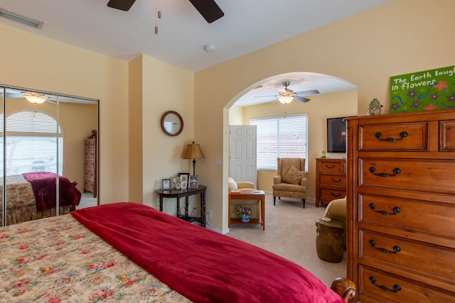 7897 Monarch Ct, Delray Beach, FL 33446 - bedroom featuring arched walkways, light colored carpet, and ceiling fan