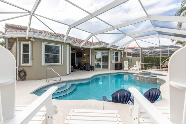 7897 Monarch Ct, Delray Beach, FL 33446 - view of swimming pool featuring a patio area, a pool with connected hot tub, and glass enclosure