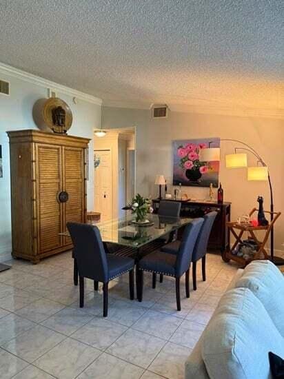 3790 Silver Lace Ln, Boynton Beach, FL 33436 - dining room featuring ornamental molding and a textured ceiling