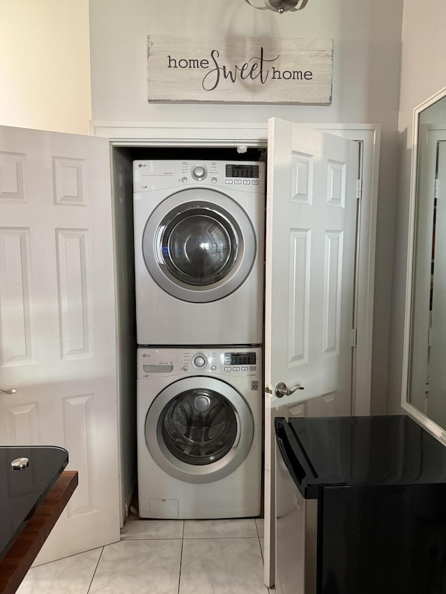 3790 Silver Lace Ln, Boynton Beach, FL 33436 - washroom with stacked washer and clothes dryer and light tile patterned floors
