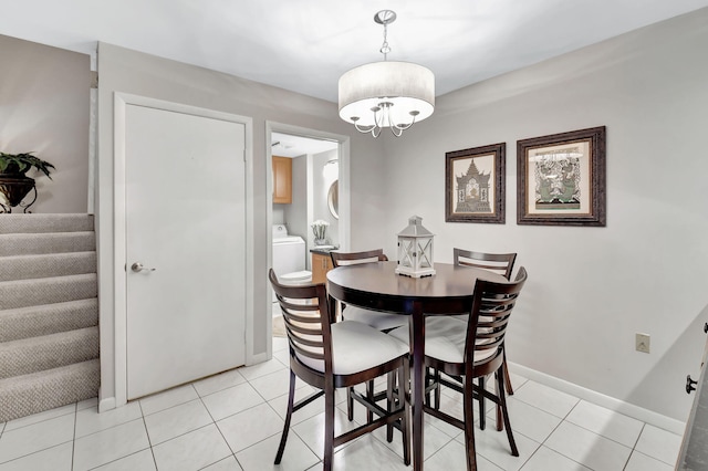 dining area with a chandelier, light tile patterned floors, stairs, and baseboards